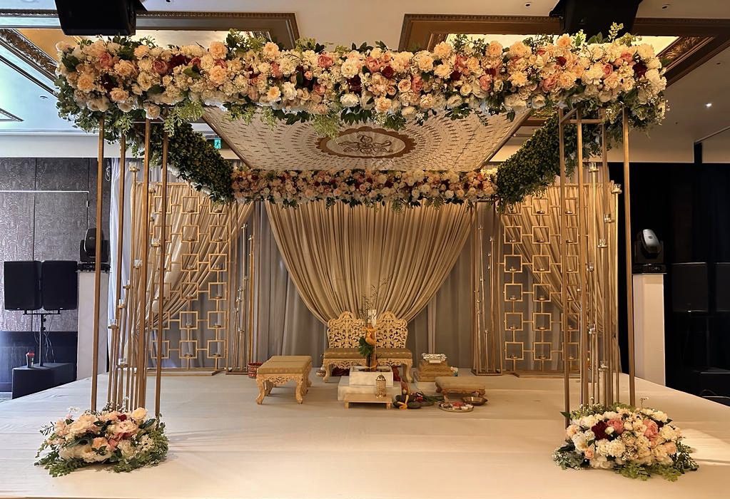 Gold Metal Mandap with Shades of peach/pink flowers