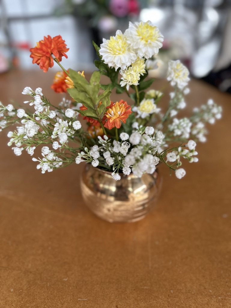 Brass vase with marigold flowers