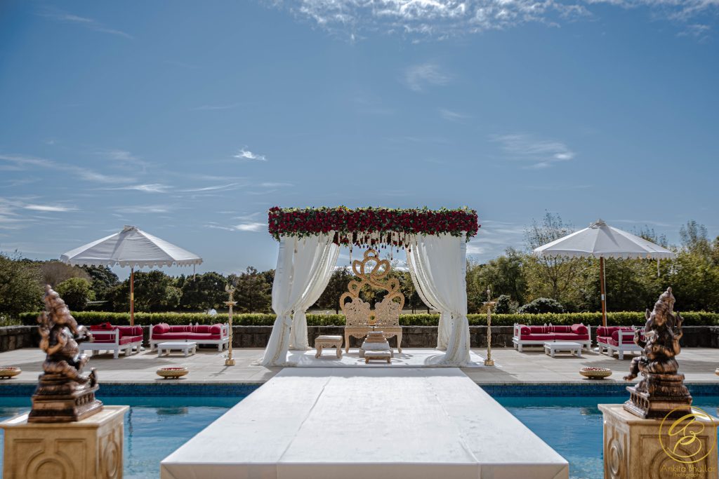 White Pillar Mandap With Maroon FLowers